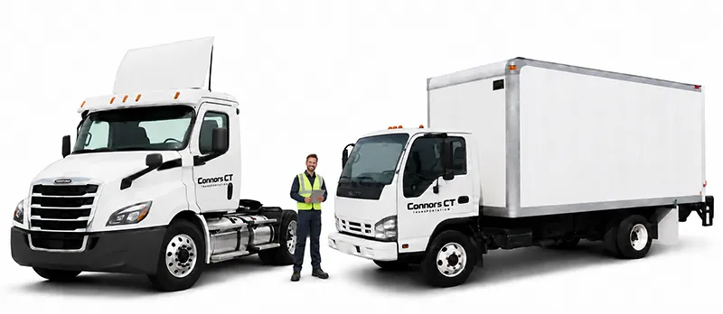 Connors Driver Standing in Front of Trucks
